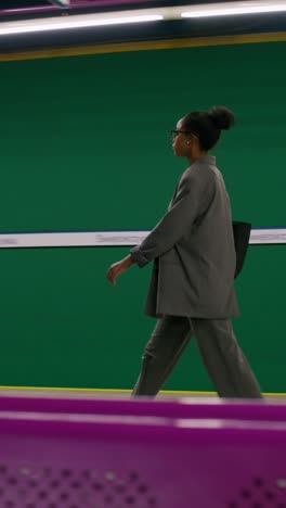 businesswoman walking through subway station