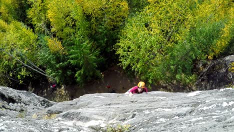 person rock climbing the cliff 4k