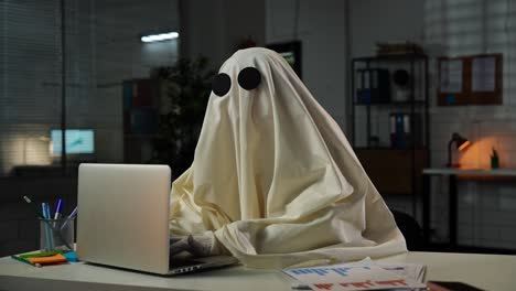 a ghost working on a laptop in an office