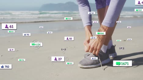 animation of social media notifications, over woman tying shoe on beach