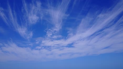 Amazing-bright-blue-heaven-with-static-veil-of-clouds-hanging-over-Atlantic-ocean,-freedom-feeling,-copy-space