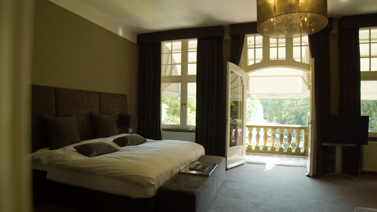 Dolly in towards beautiful double bed in hotel room