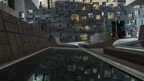 Rotating Shot Of Stunning Building Exterior Reflecting On Glasses On The Ground - Barcode Project In Downtown Oslo At Sunset - time lapse, zoom-in