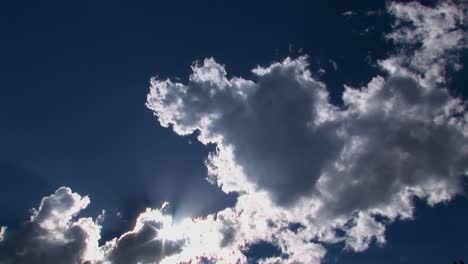 a time lapse of white clouds moving across a blue sky