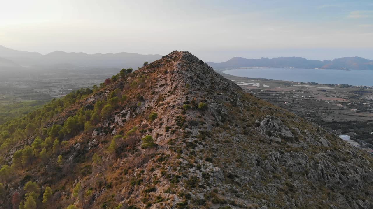 Wide angle Dolly In Drone shot of Mountains, Mediterranean Sea, and Surrounding Landscapes of Mallorca (Majorca) Island during the day