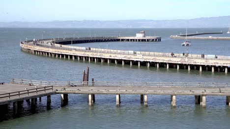 people enjoying a walk by the pier in san francisco, california