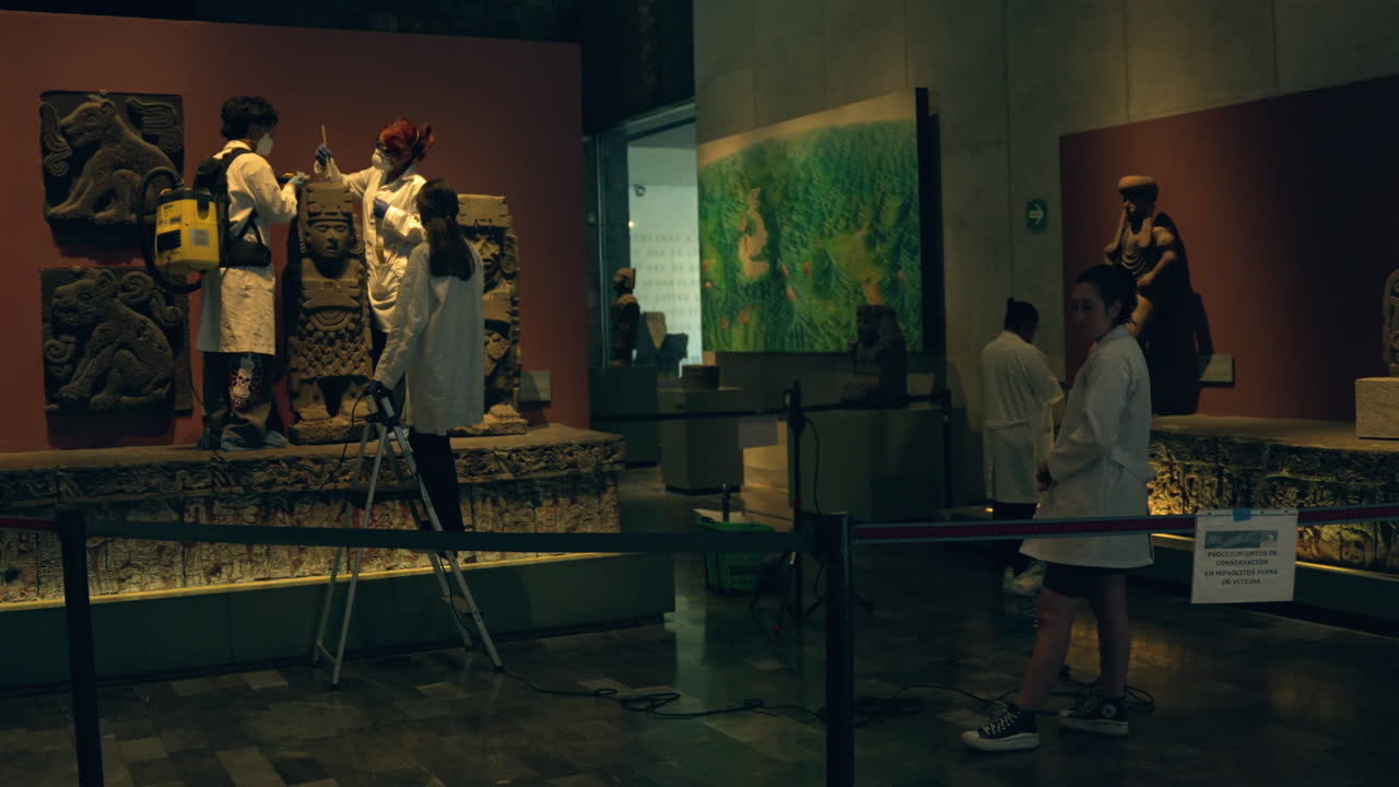 Art Conservators Cleaning The Artifacts And Sculptures With Brush And Vacuum At Great Temple of Mexico-Tenochtitlan.