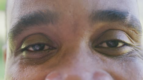 Portrait-of-happy-african-american-man-looking-at-camera-and-smiling,-in-slow-motion