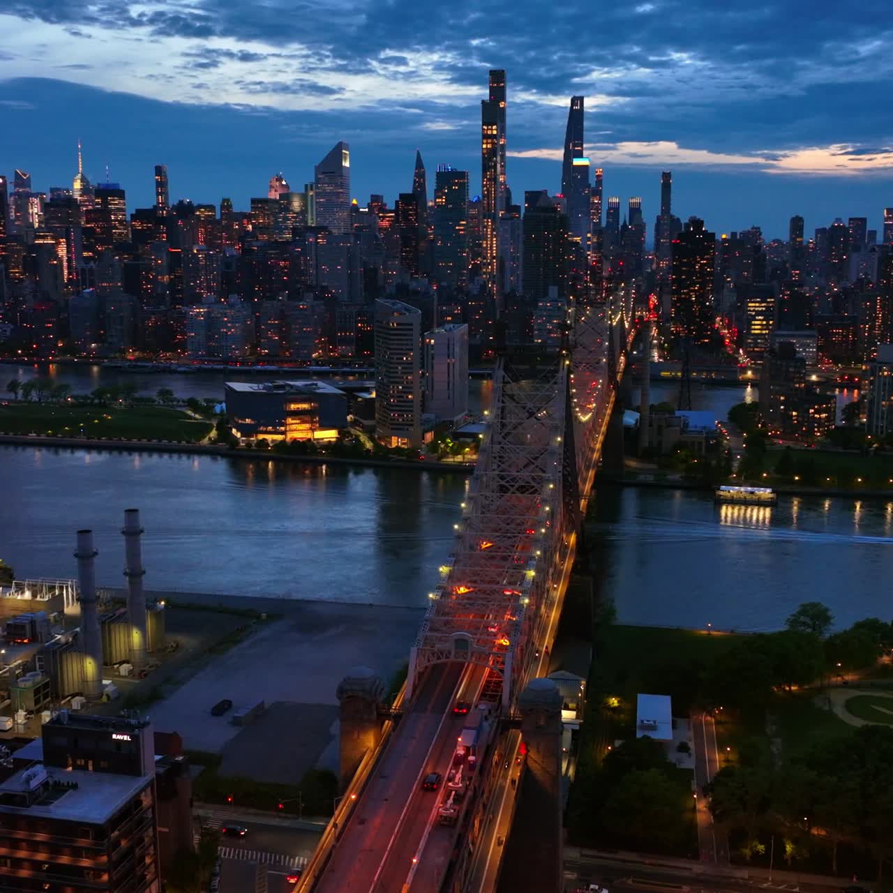 Stunning cityscape of New York in the lights. Spectacular Queensboro Bridge over East River at the backdrop of skyscrapers at night