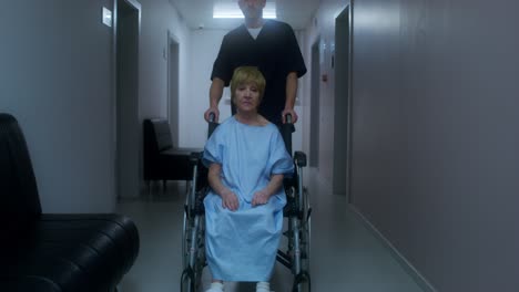 elderly patient in wheelchair being assisted by a doctor