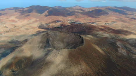 gairia volcanic caldera: aerial shot traveling out to the crater of the volcanic caldera on a sunny day and with beautiful colors of the day