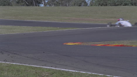 racing cars race around a track 1