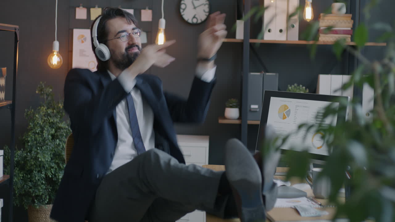 Businessman Relaxing and Dancing in Office