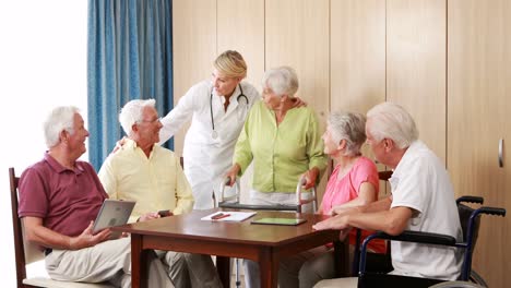 female doctor interacting with senior citizens