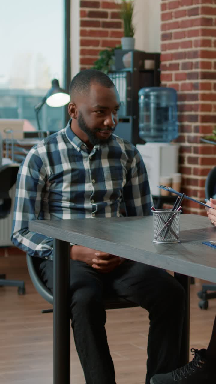 Man sitting at a table in an office setting
