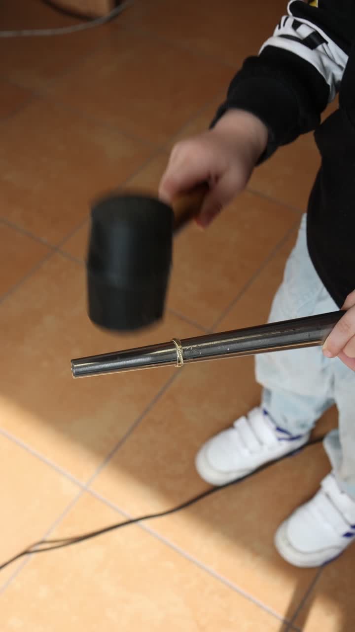 Child's Hands Using a Rubber Mallet to Work on a Ring