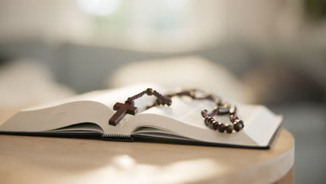 Bible,-open-and-rosary-on-table-for-religion