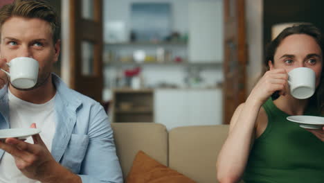 resting spouses drinking tea sofa together zoom on. love couple enjoying coffee