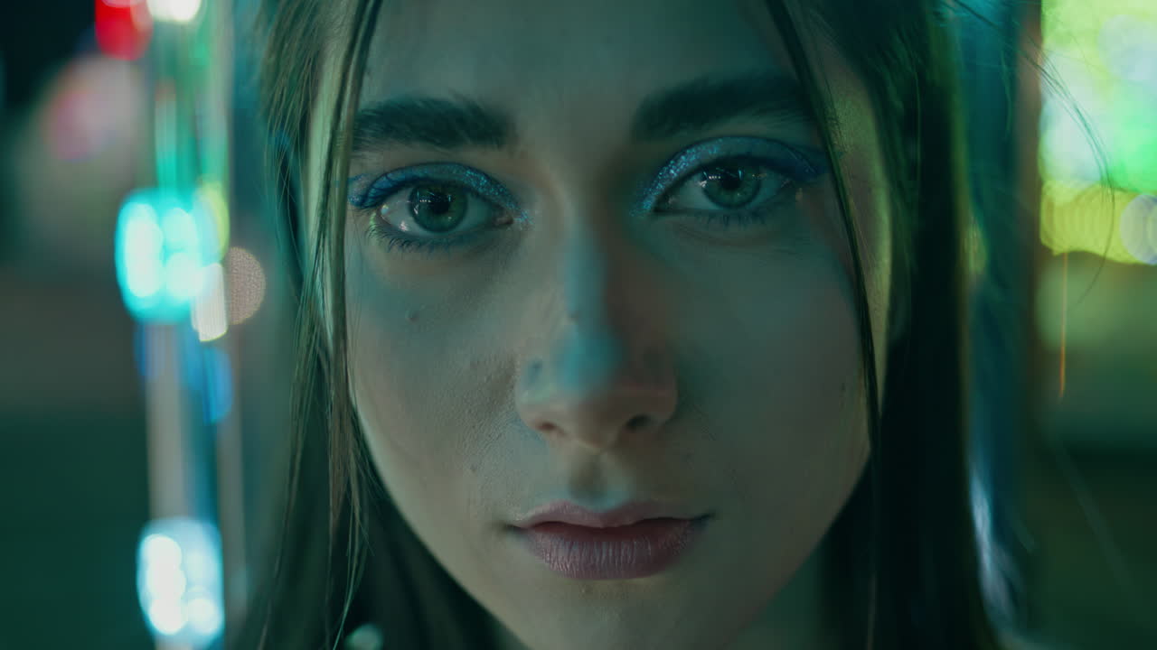 Portrait neon girl looking camera. Attractive woman with night club party makeup