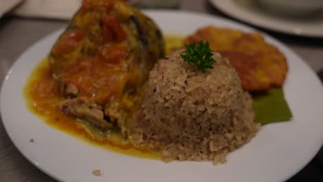 coconut rice with catfish and fried plantain. close up