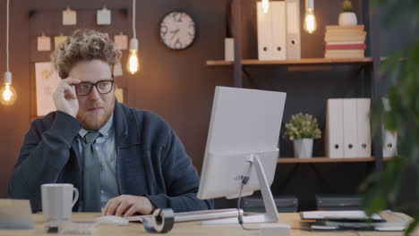man concentrating at his computer in a modern office