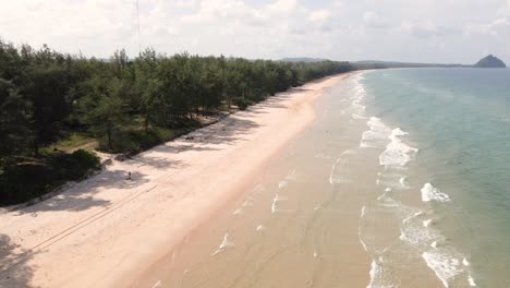 Drone-Pan-Down-En-La-Playa-En-Chumphon,-Tailandia-Con-Olas-Del-Océano-A-Lo-Largo-De-La-Playa-Con-Arena-En-Un-Día-Soleado