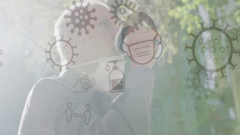 animación de iconos de covid-19 sobre un hombre mayor que usa una máscara facial