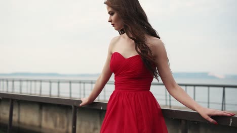 woman in a red dress by the lake