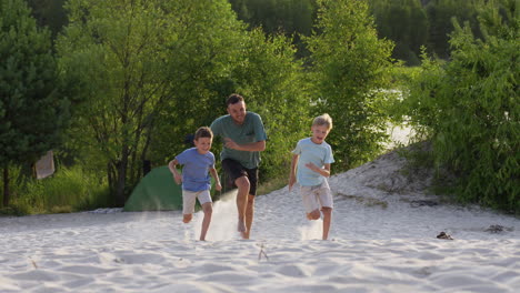 family running on the beach