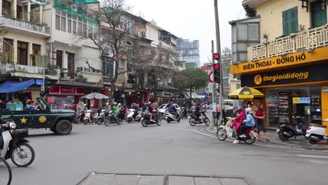 traffic and pedestrians crossing a busy city junction