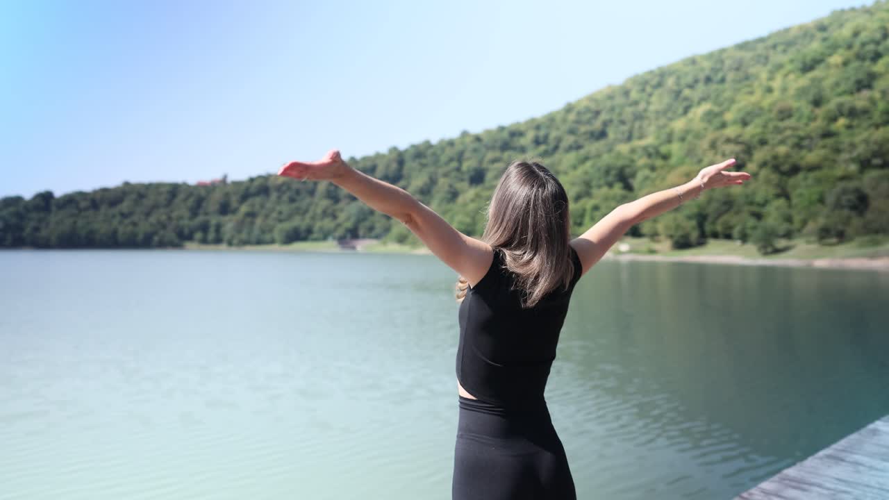 Woman enjoying nature at a tranquil lake
