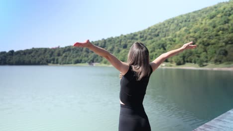 woman enjoying nature at a tranquil lake