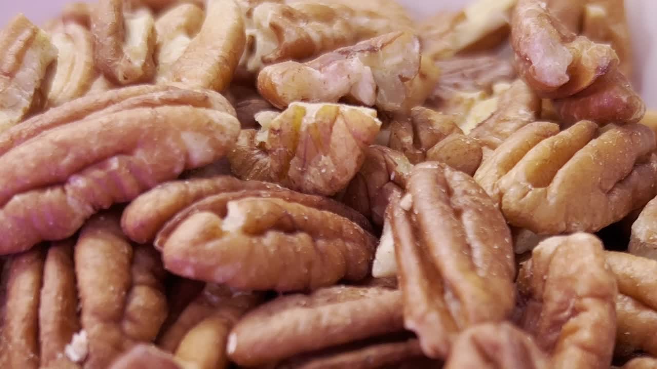 Exteme close up macro shot of Pecan halves forming a textured background, highlighting themes of healthy eating, baking, ideal for showcasing nutrition and delicious recipes