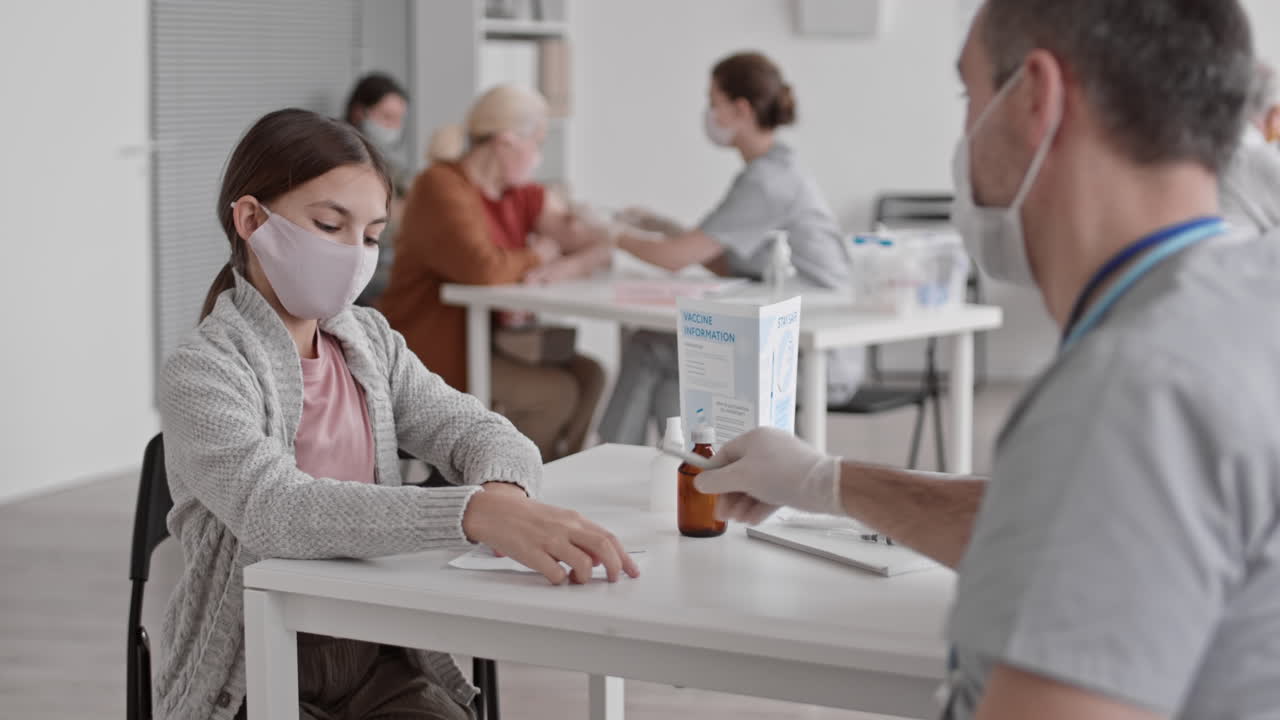 School-aged Girl Posing with Vaccination Certificate