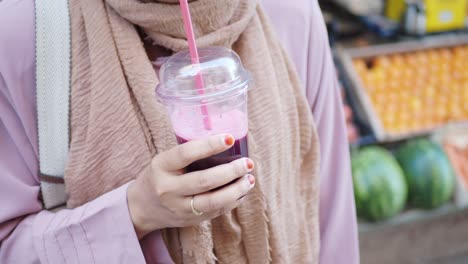 woman with a juice at a fruit market