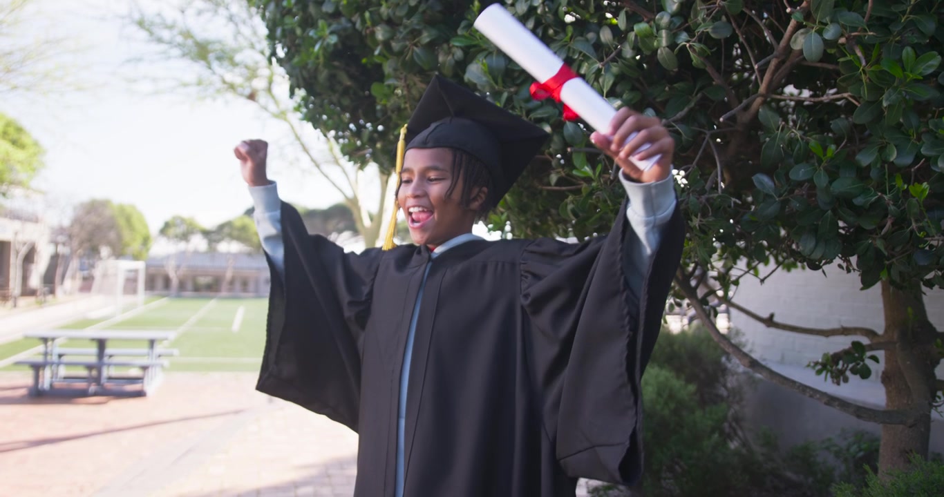 African-American teen wearing gown, tassel at school reading red ribbon diploma untying yelling