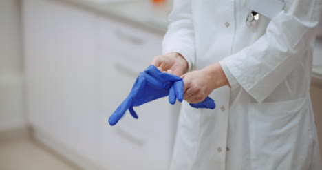 close up of female doctor wearing gloves