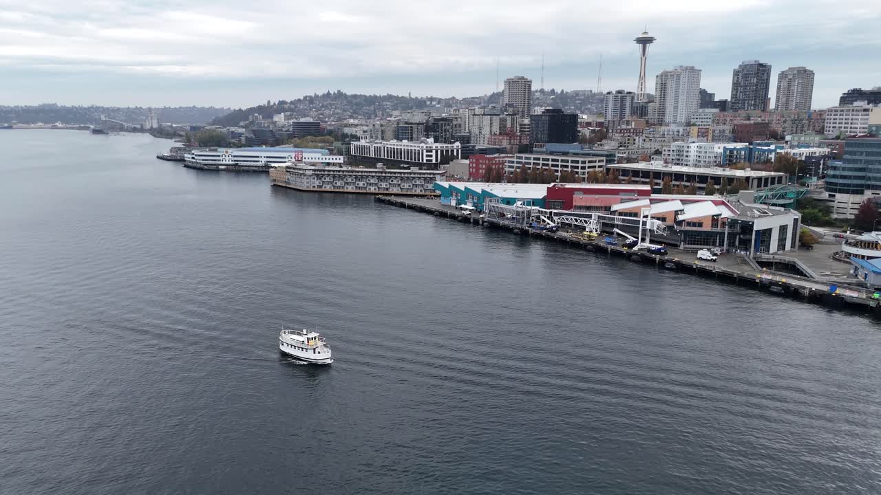 Drone over Elliott Bay and the ocean, capturing Seattle full skyline, waterfront, and cityscape cinematic aerial shot