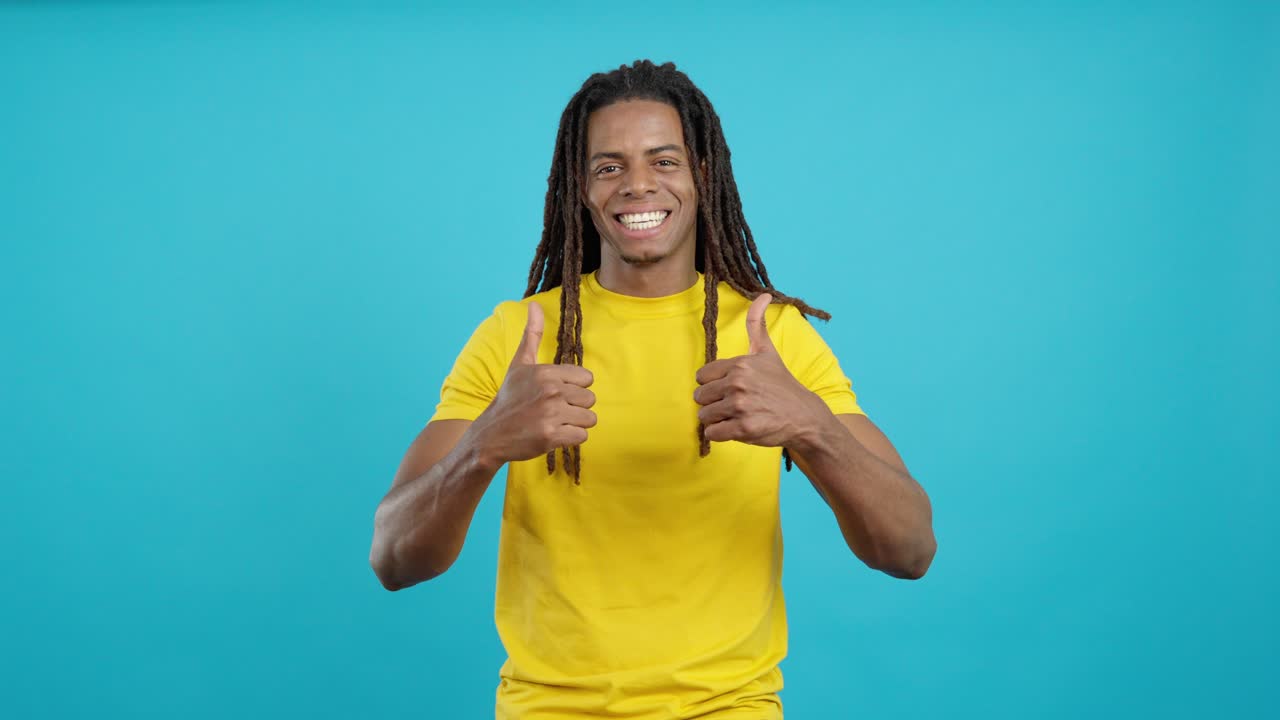 Man with dreadlocks giving thumbs up