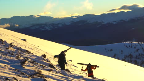 cinematic epic ikon vail pass colorado golden hour sunset father son skiers hike across rocks with skis on shoulders above tree line powder epic rocky mountain landscape backcountry scenic follow pan