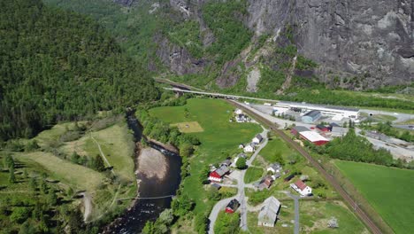 Dale-river-Bergensbanen-railway-and-road-E16-close-by---Beautiful-summer-day-aerial-overview-of-river-and-Dalegarden-industry-area---Dale-Vaksdal-Norway