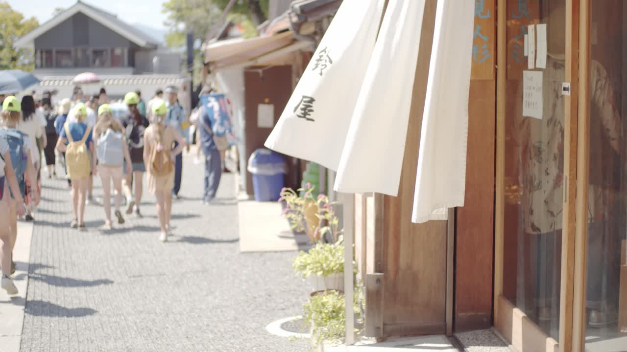 Restaurant curtains waving with people walking in the background in Kyoto, Japan soft lighting slow motion 4K