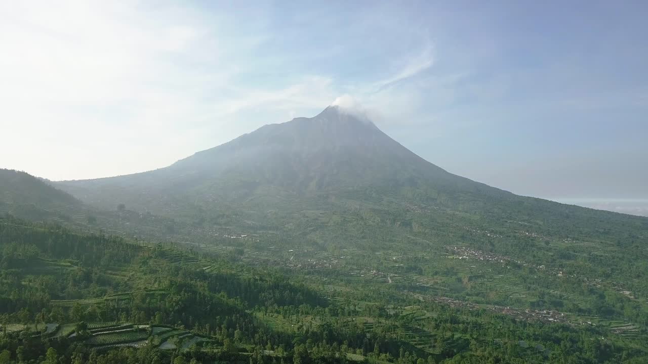 Merapi volcano with rural view of plantation that planted with brocolli, cabbage, potatoes and green onions, central java, Indonesia. agricultural industry
