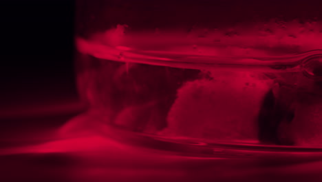 red lit water in glass container