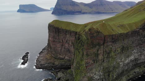 aerial of the incredibly beautiful landscape at the lighthouse kalsoy on the cliffs in the ocean on the faroe islands