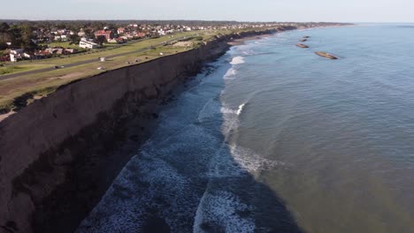 aerial flyover famous destination of mar del plata cliffs in argentina during sunset - 4k drone flight