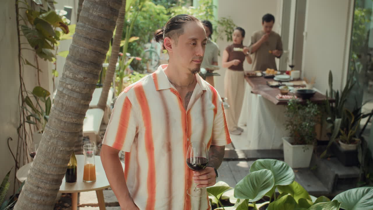 Portrait of Multi-ethnic Man Posing with Glass of Wine during Grill Party