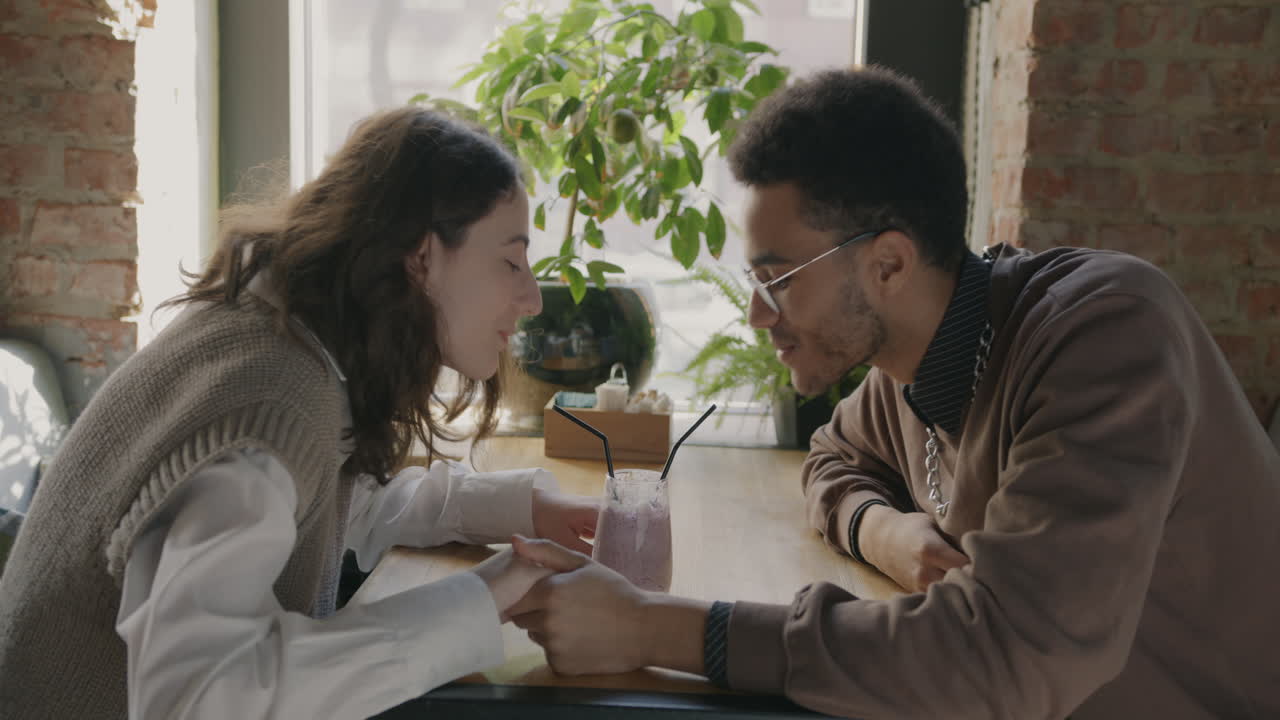 Couple Enjoying Smoothie in a Cafe