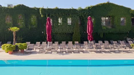 swimming pool water, sunbeds in slow motion