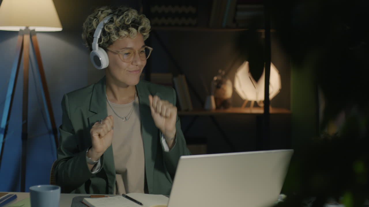 Woman Working and Enjoying Music Online